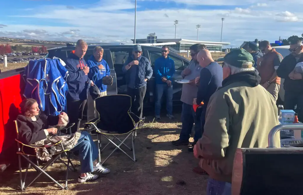 men standing in a circle praying